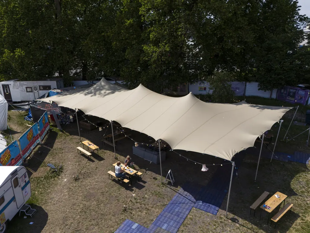 Our stretch tent from above, with picnic benches around it