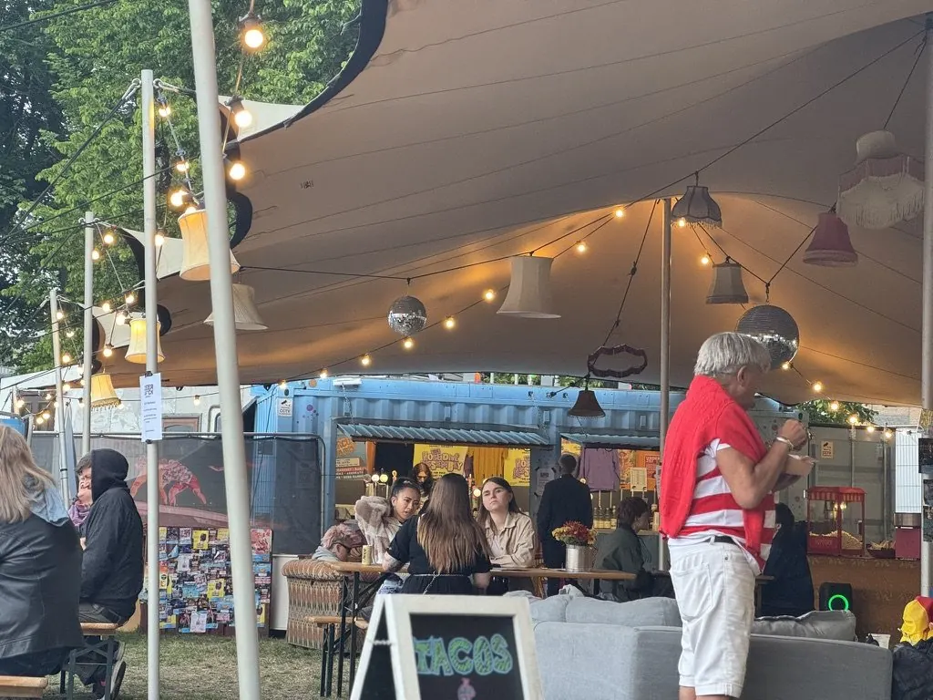 Our stretch tent in the evening, with people and food trucks